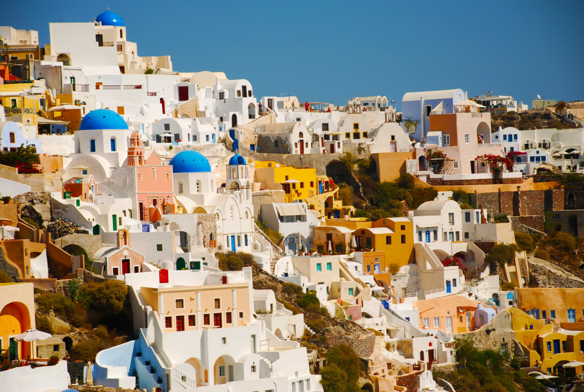 Scenic view of white houses on a hillside in Santorini, Greece – Explore Places blog image